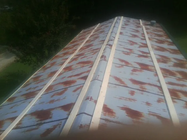 Rusted metal roof panels with new wood purlins before replacement — Storm Damage Roof Repair in Wallsburg by Roofing Brothers